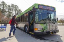 young woman about to board Route 100