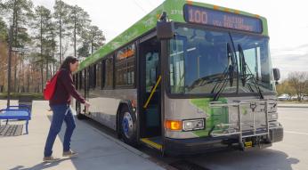young woman about to board Route 100