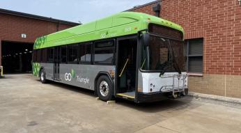 a new green GoTriangle bus